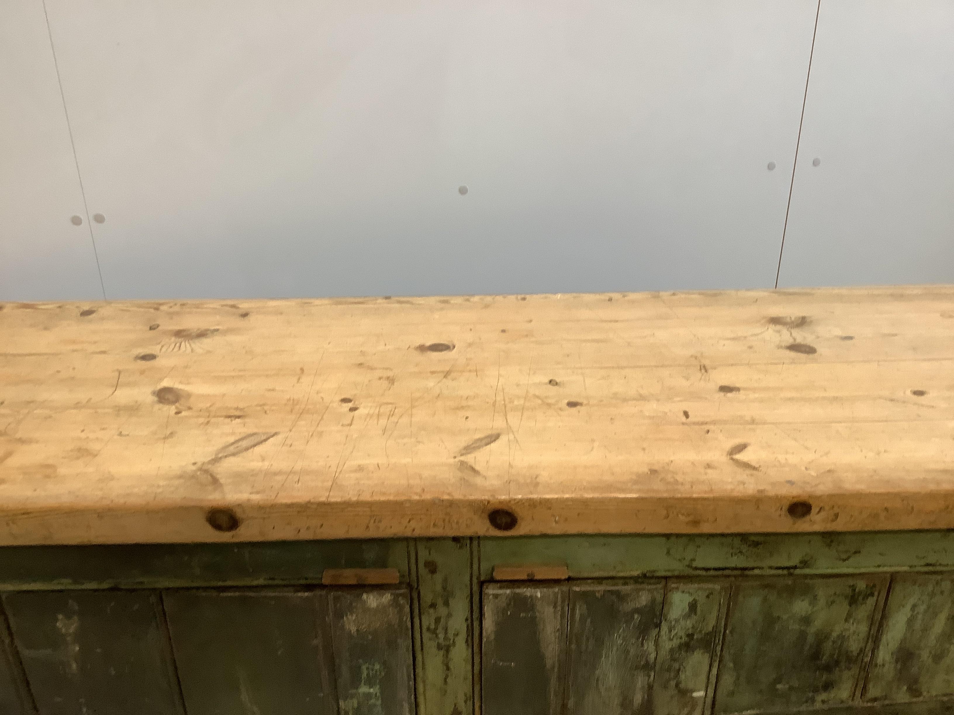 A provincial painted pine two door side cabinet, width 147cm, depth 52cm, height 124cm